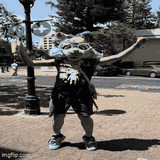 Costumed character dancing outdoors